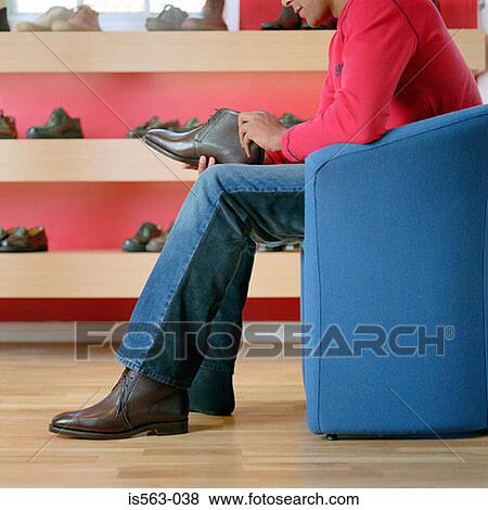 Man in shoe store View Large Photo Image Stock Photo - Man in shoe store. Fotosearch