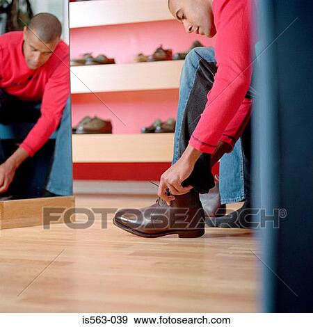 Stock Photo - Man in shoe store. Fotosearch