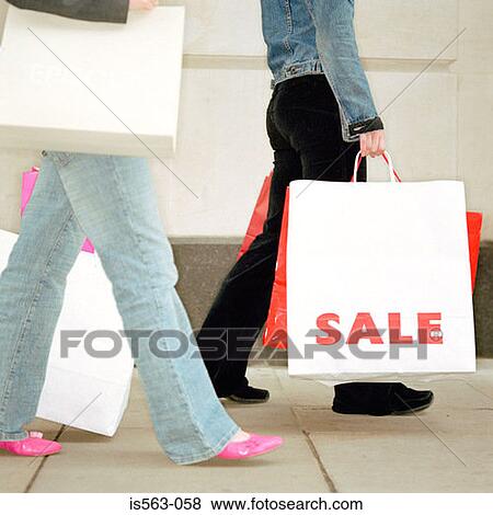 Women carrying shopping bags View Large Photo Image Stock Photo - Women carrying shopping bags. Fotosearch