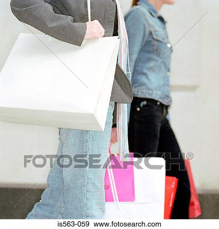 Women carrying shopping bags View Large Photo Image Stock Photo - Women carrying shopping bags. Fotosearch