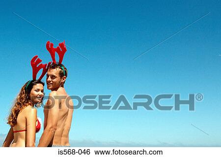 Couple with reindeer head decoration View Large Photo Image Stock Photograph - Couple with reindeer head decoration. Fotosearch