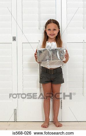 Happy girl holding a present View Large Photo Image Stock Photograph - Happy girl holding a present. Fotosearch