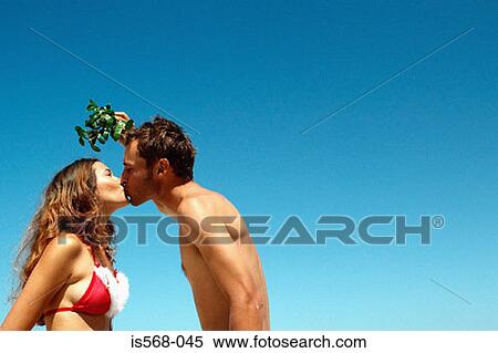 Stock Photography - Kissing under mistletoe . Fotosearch