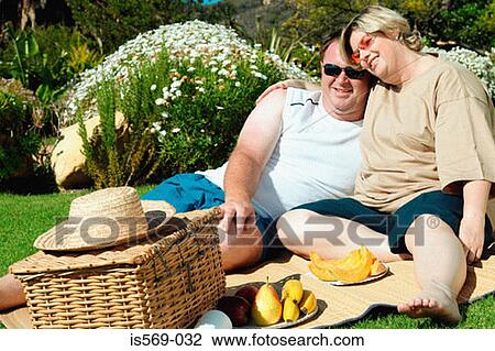 Happy couple having a picnic View Large Photo Image Stock Image - Happy couple having a picnic . Fotosearch