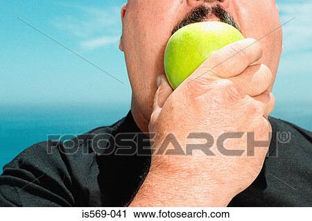 Large man eating an apple View Large Photo Image Stock Image - Large man eating an apple . Fotosearch