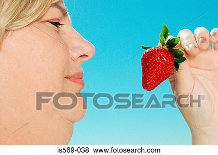Large woman looking at strawberry View Large Photo Image Stock Photo - Large woman looking at strawberry. Fotosearch