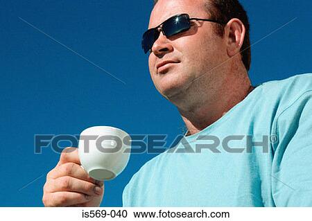 Man holding a coffee cup View Large Photo Image Stock Image - Man holding a coffee cup. Fotosearch