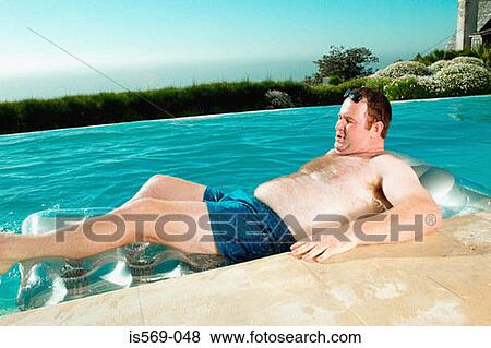 Man on lilo View Large Photo Image Stock Photo - Man on lilo. Fotosearch