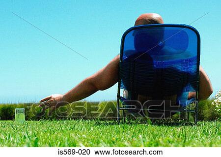 Man sunbathing View Large Photo Image Stock Image - Man sunbathing. Fotosearch