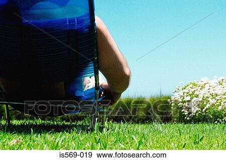 Man sunbathing View Large Photo Image Stock Photo - Man sunbathing. Fotosearch