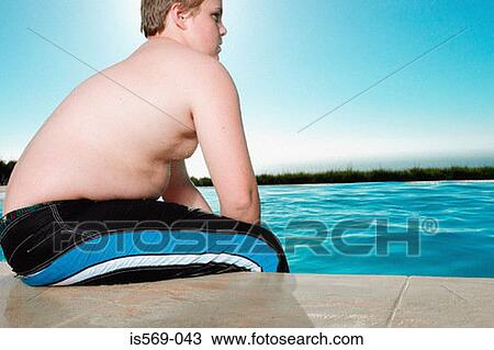 Stock Image - Overweight boy having a break from swimming. Fotosearch