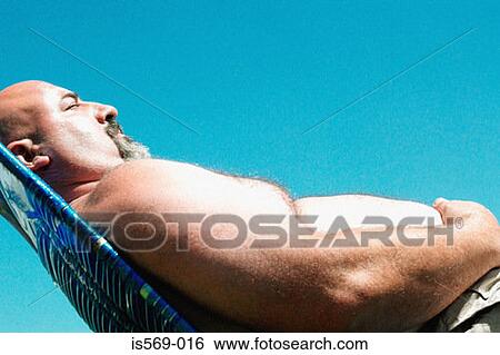Overweight man sunbathing View Large Photo Image Stock Photograph - Overweight man sunbathing. Fotosearch