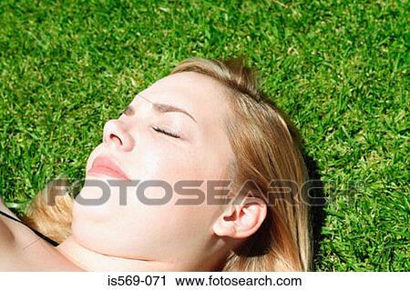 Woman sunbathing View Large Photo Image Stock Image - Woman sunbathing. Fotosearch
