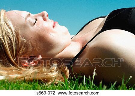 Woman sunbathing View Large Photo Image Stock Image - Woman sunbathing. Fotosearch