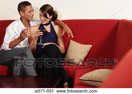 Couple drinking on sofa View Large Photo Image Stock Image - Couple drinking on sofa. Fotosearch