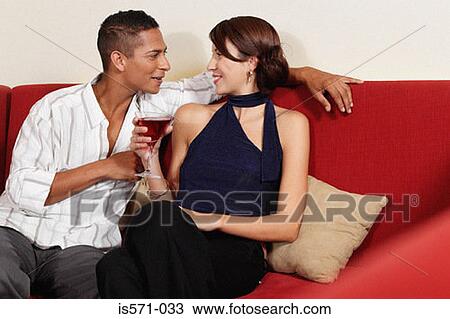 Couple drinking on sofa View Large Photo Image Stock Image - Couple drinking on sofa. Fotosearch