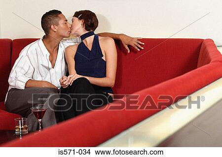 Couple kissing on sofa View Large Photo Image Picture - Couple kissing on sofa. Fotosearch