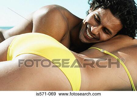 Couple lying on beach View Large Photo Image Stock Photo - Couple lying on beach. Fotosearch