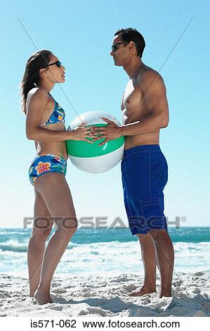 Couple playing with beach ball View Large Photo Image Stock Image - Couple playing with beach ball. Fotosearch