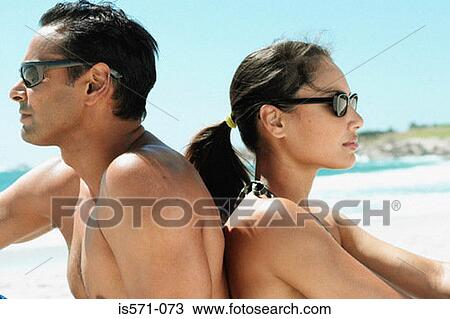 Couple sitting on beach View Large Photo Image Stock Image - Couple sitting on beach. Fotosearch