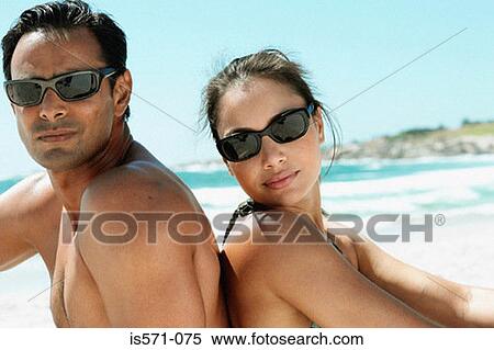 Couple sitting on beach View Large Photo Image Stock Photography - Couple sitting on beach. Fotosearch