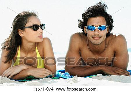 Couple sunbathing View Large Photo Image Picture - Couple sunbathing. Fotosearch
