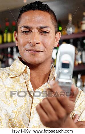 Man holding cellular telephone View Large Photo Image Stock Photo - Man holding cellular telephone. Fotosearch