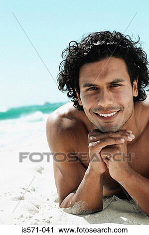 Man sunbathing on beach View Large Photo Image Stock Image - Man sunbathing on beach. Fotosearch