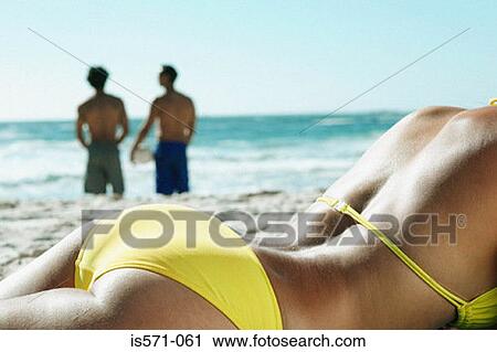 Woman sunbathing on beach View Large Photo Image Stock Image - Woman sunbathing on beach. Fotosearch