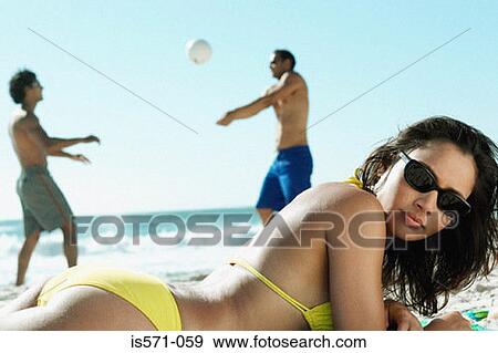 Woman sunbathing on beach View Large Photo Image Stock Photo - Woman sunbathing on beach. Fotosearch