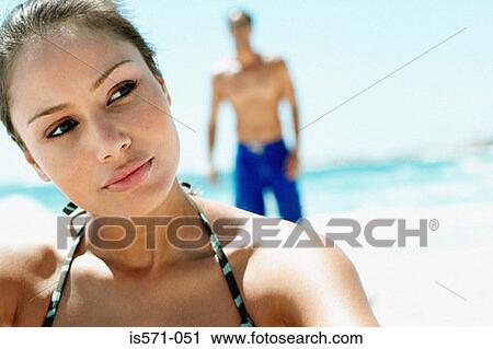 Stock Image - Young woman on beach. Fotosearch
