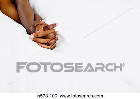 Couple holding hands in bed View Large Photo Image Stock Image - Couple holding hands in bed. Fotosearch