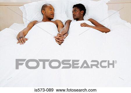 Stock Photo - Couple lying in bed. Fotosearch