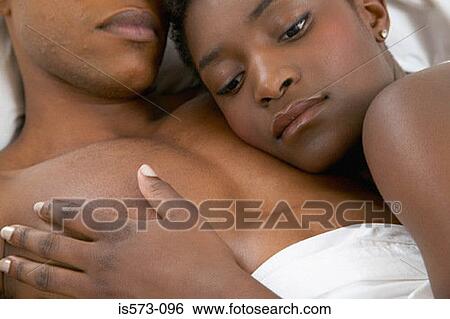 Couple lying in bed View Large Photo Image Stock Photograph - Couple lying in bed. Fotosearch