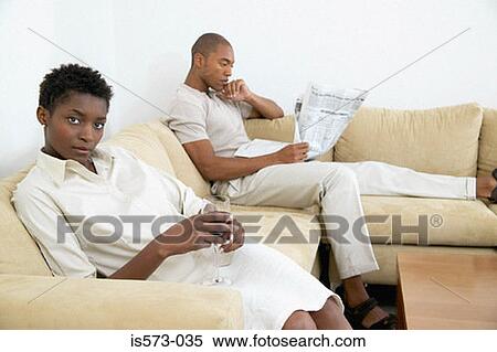 Stock Photography - Couple relaxing on sofa. Fotosearch