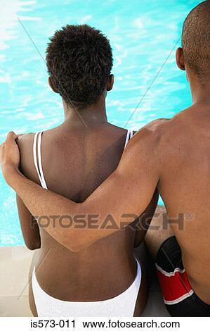 Couple sitting near pool View Large Photo Image Stock Image - Couple sitting near pool. Fotosearch