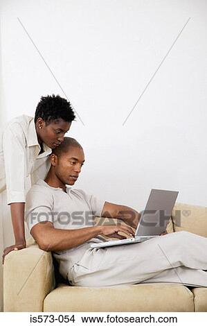 Couple using laptop computer View Large Photo Image Picture - Couple using laptop computer. Fotosearch