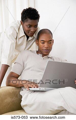Stock Image - Couple using laptop computer. Fotosearch