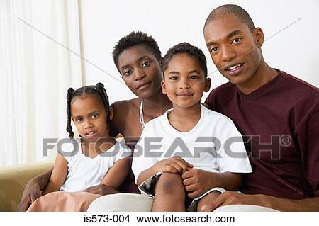 Picture - Family sitting on sofa. Fotosearch