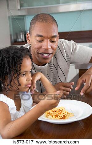 Father and daughter at dining table View Large Photo Image Stock Photo - Father and daughter at dining table. Fotosearch
