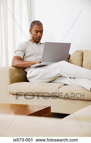 Stock Image - Man using laptop computer. Fotosearch
