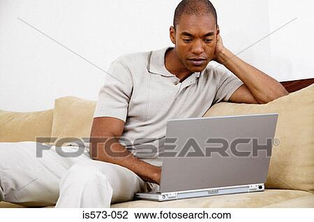 Stock Image - Man using laptop computer. Fotosearch