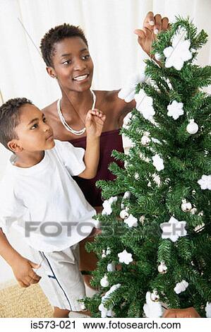 Mother and son decorating christmas tree View Large Photo Image Stock Image - Mother and son decorating christmas tree. Fotosearch
