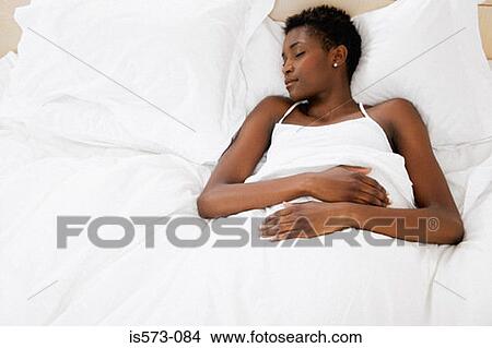 Picture - Woman resting in bed. Fotosearch