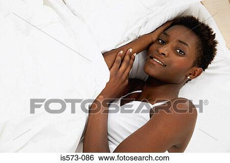 Woman resting in bed View Large Photo Image Stock Photograph - Woman resting in bed. Fotosearch