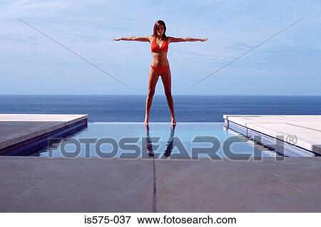 Young woman at swimming pool by the sea View Large Photo Image Stock Photo - Young woman at swimming pool by the sea. Fotosearch