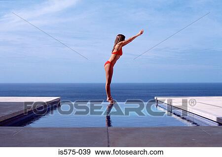 Young woman at swimming pool by the sea View Large Photo Image Stock Photo - Young woman at swimming pool by the sea. Fotosearch