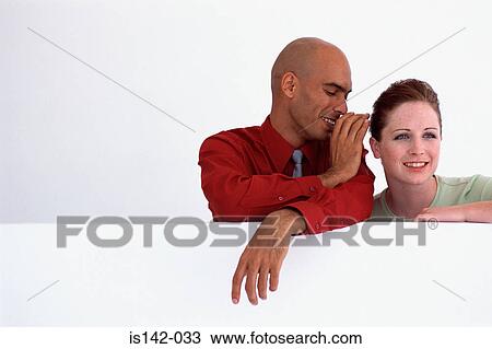 Stock Image - Male whispers to female. Fotosearch