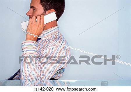 Stock Image - Man with telephone to his ear. Fotosearch
