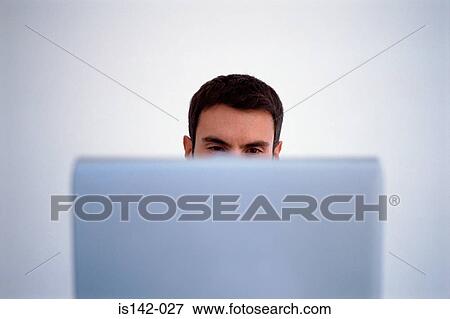 Stock Photo - Man working on laptop. Fotosearch